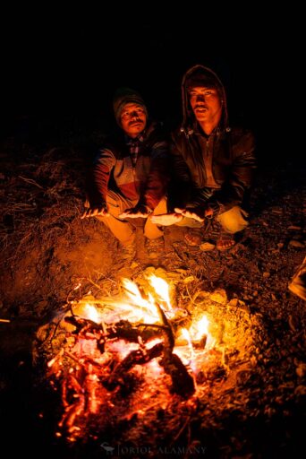 Dolpo porters near a fire camp at night